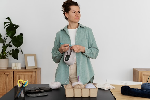 Young adult organizing their knitting products