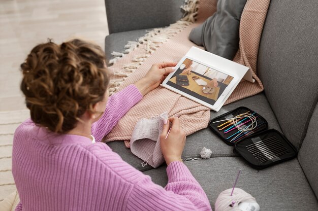 Young adult organizing their knitting products