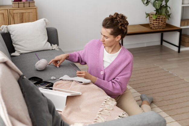 Young adult organizing their knitting products