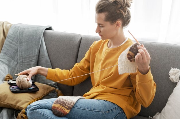 Young adult organizing their knitting products