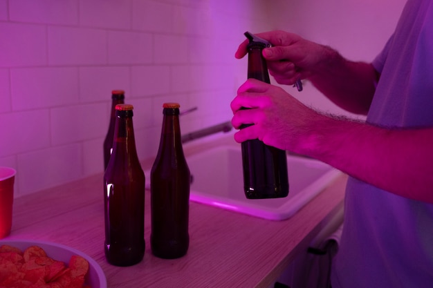 Young adult preparing drinks for beer pong