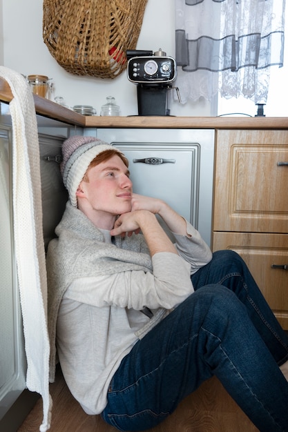 Free photo young adult ready for knitting at home