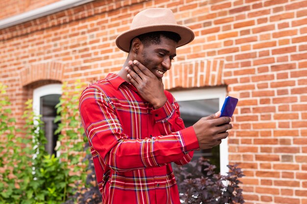 Young adult in red shirt taking a close-up selfie