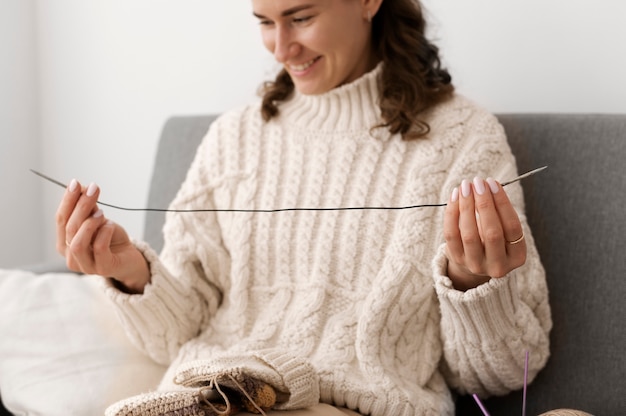 Free photo young adult relaxing while knitting