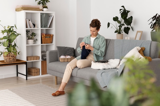 Young adult relaxing while knitting