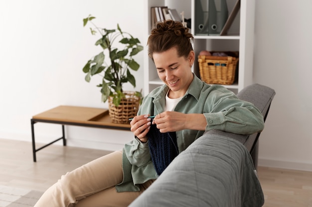 Young adult relaxing while knitting