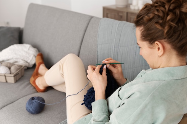 Young adult relaxing while knitting