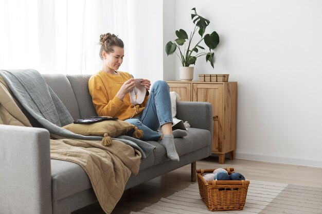 Young adult relaxing while knitting