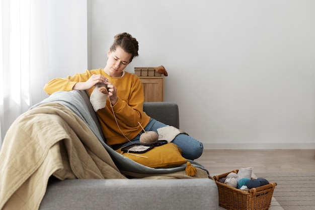 Young adult relaxing while knitting