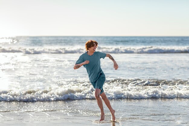 Young adult running near seaside