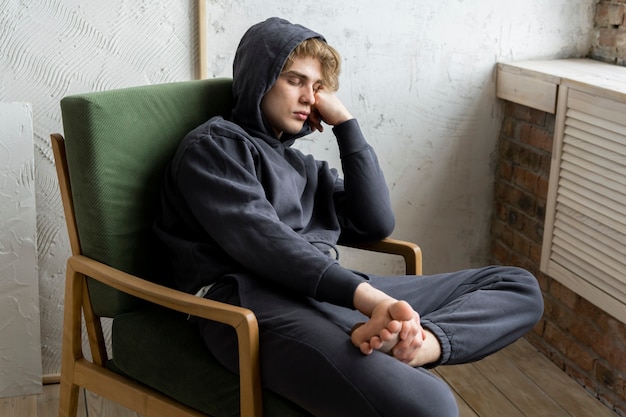 Free photo young adult sleeping on chair