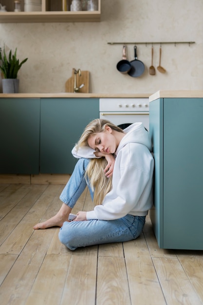 Free photo young adult sleeping in kitchen