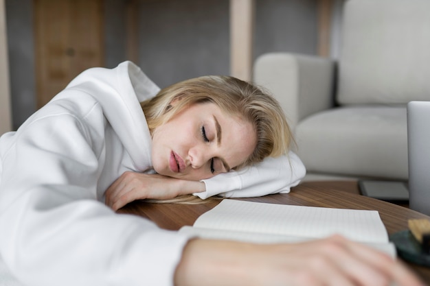 Free photo young adult sleeping while doing homework