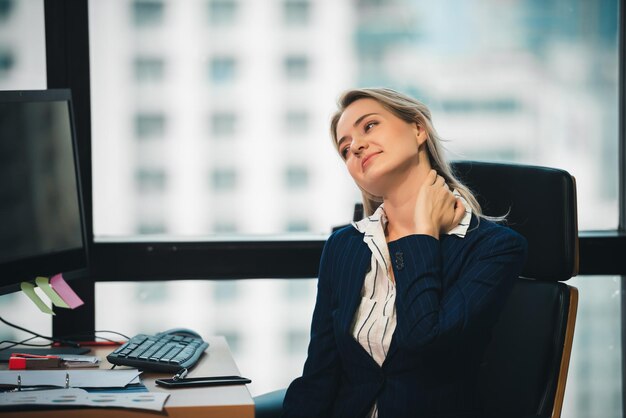 Young adult smart business woman in black casual suit working with computer in urban office