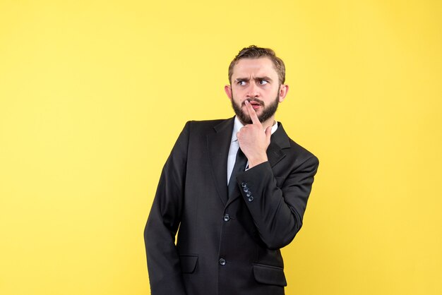 Young adult thinking about high resolution with his suit on yellow