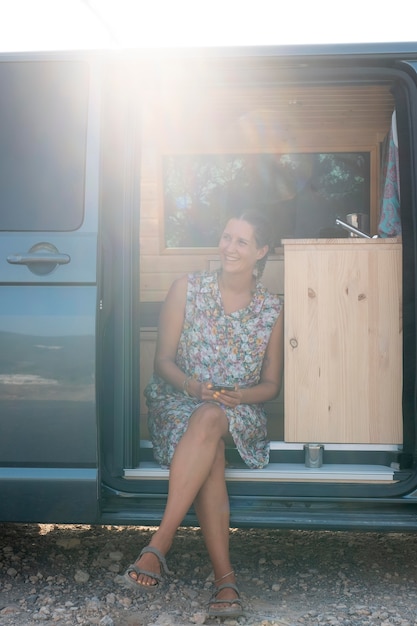 Free photo young adult travelling in her van