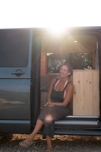 Free photo young adult travelling in her van