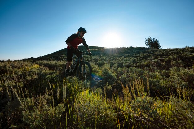 Young adult using electric bike in the country side