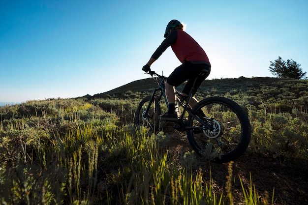 Free photo young adult using electric bike in the country side