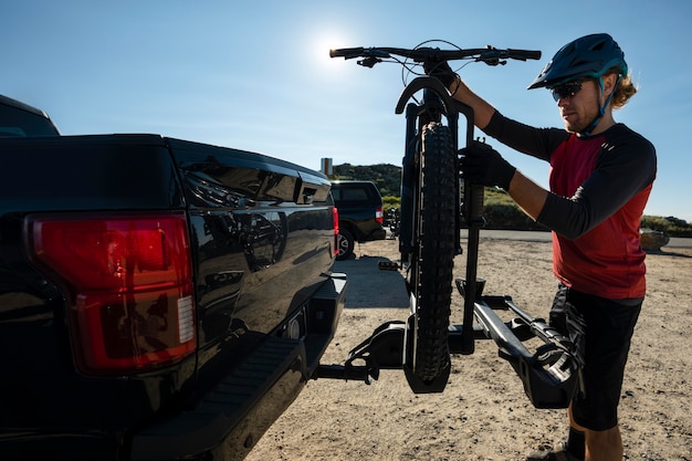 Free photo young adult using electric bike in the country side