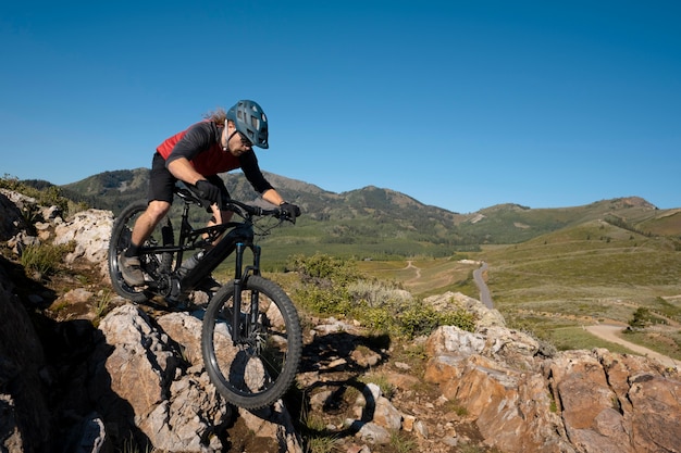 Young adult using electric bike in the country side