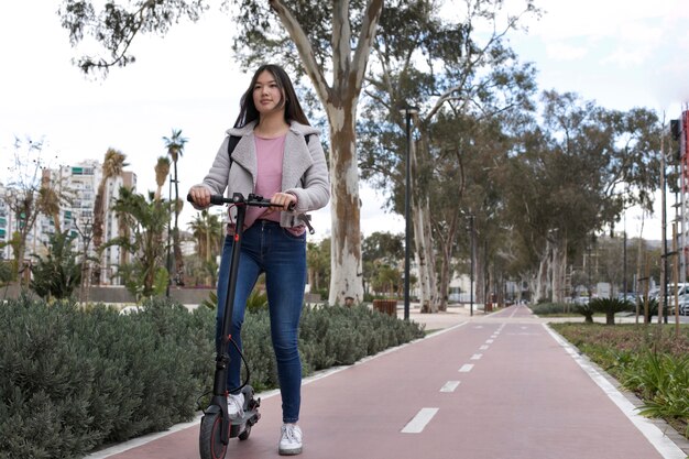 Young adult using electric scooter for transportation