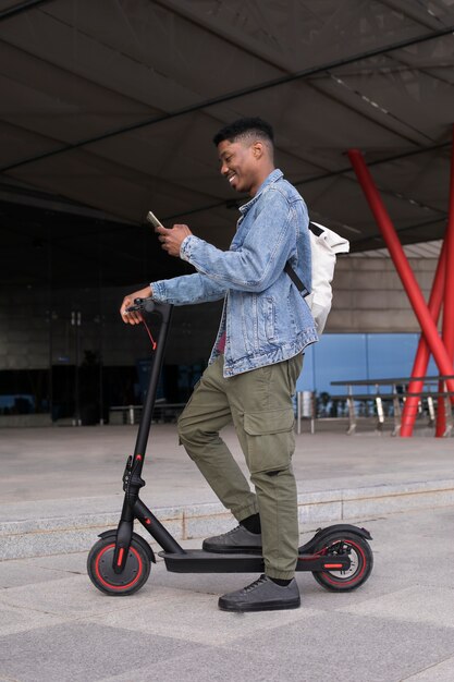 Young adult using electric scooter for transportation