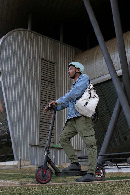 Young adult using electric scooter for transportation