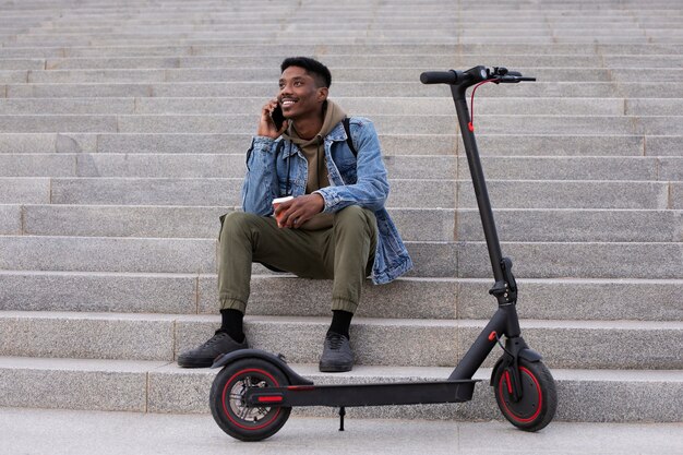 Young adult using electric scooter for transportation