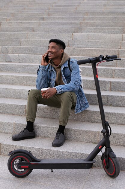 Young adult using electric scooter for transportation