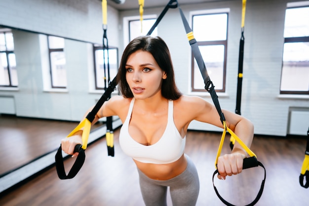 Young adult woman doing exercises in the gym