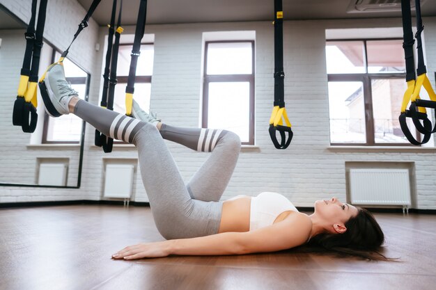 Young adult woman doing exercises in the gym