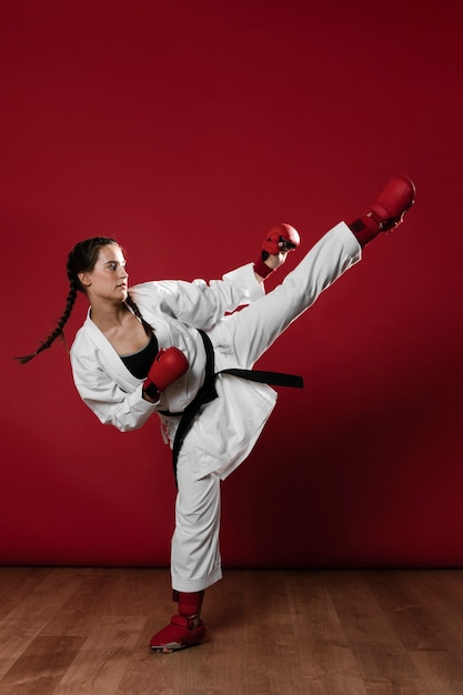 Young adult woman with black belt fighter training karate