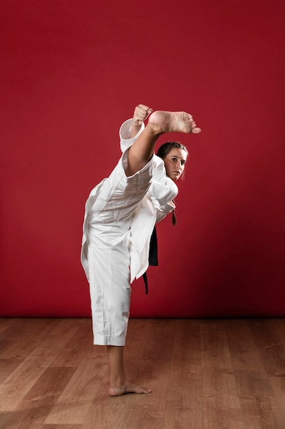 Free photo young adult woman with black belt fighter training karate