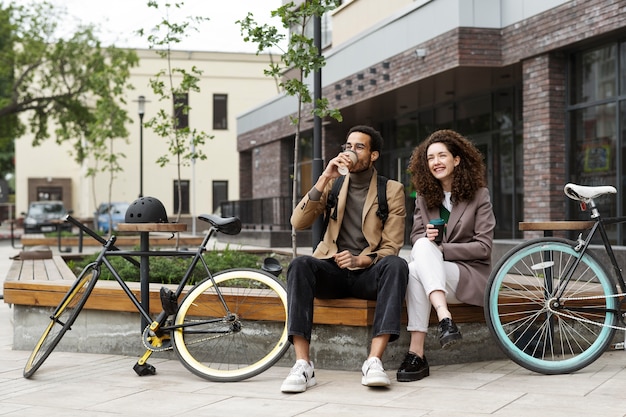 Young adults cycling to work in the city