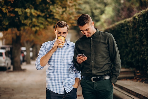 Young adults guys walking together inpark