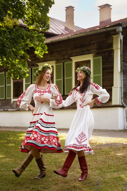 Free photo young adults having fun while folk dancing