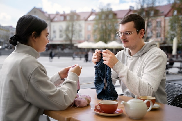 Young adults knitting outside