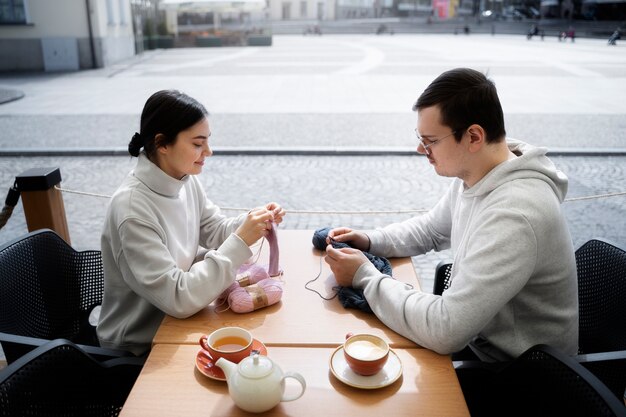 Young adults knitting outside