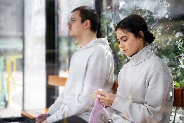 Young adults knitting outside