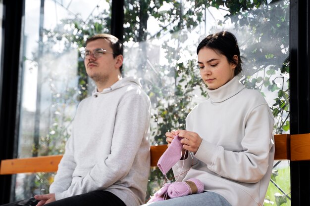 Young adults knitting outside