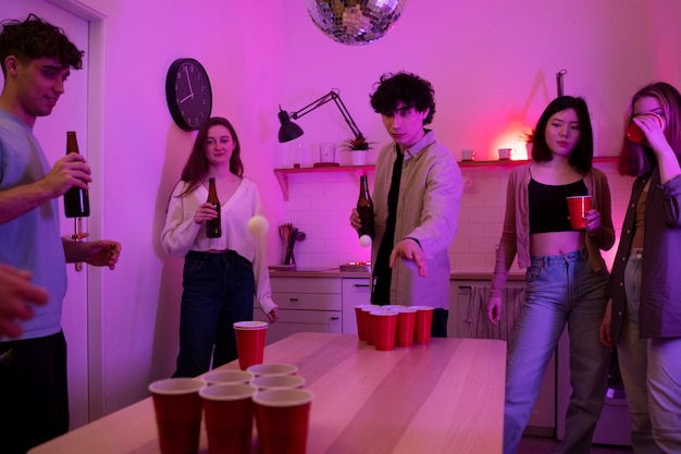 Young adults playing beer pong