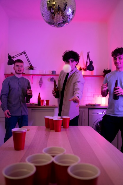 Free photo young adults playing beer pong