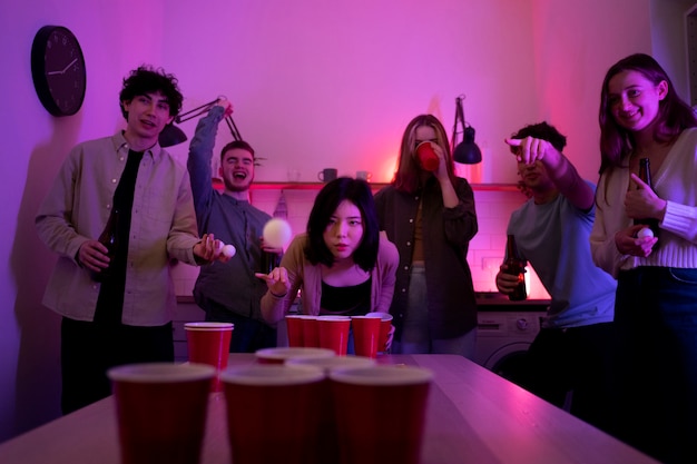 Young adults playing beer pong