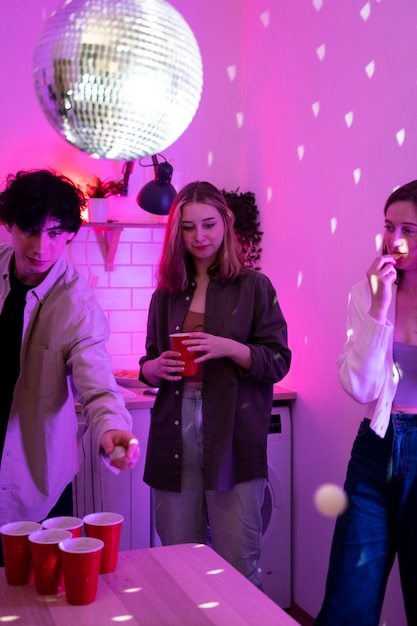 Young adults playing beer pong