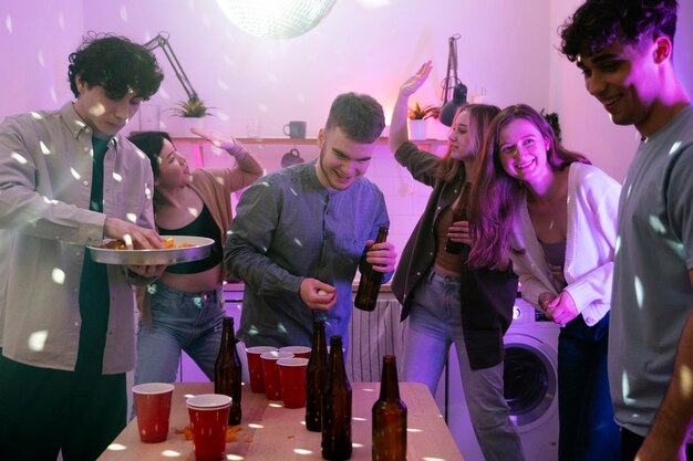 Young adults playing beer pong