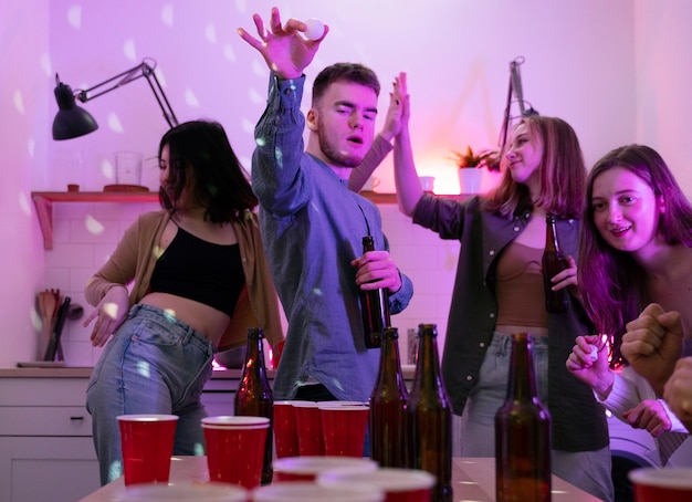 Young adults playing beer pong