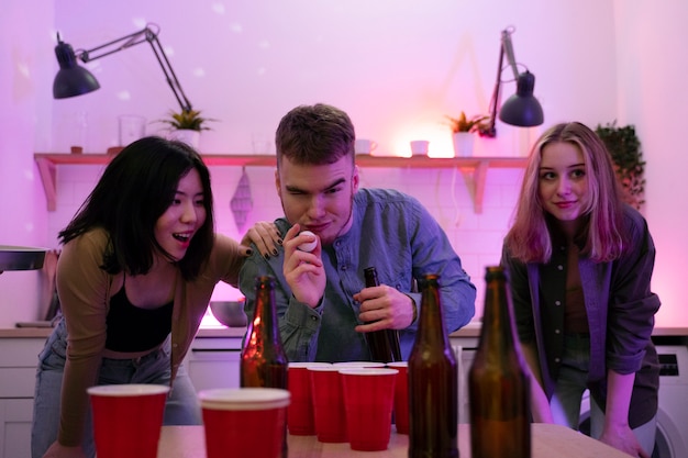 Young adults playing beer pong