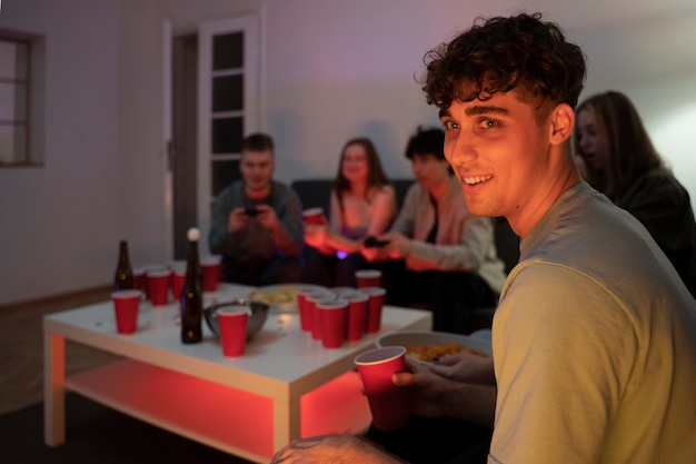 Young adults playing beer pong