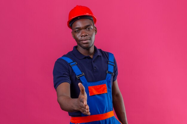 Young african american builder man wearing construction uniform and safety helmet